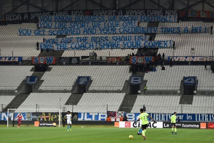 Sending a message: the teams warmed up before an empty south stand at Marseille on Friday