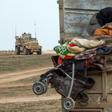 Hundreds of civilians have poured out of the last Islamic State group enclave in eastern Syria in recent days overwhelming the capacity of advancing Kurdish-led forces to process them
