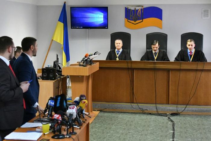 Lawyers (L) for ousted Ukrainian leader Viktor Yanukovych stand as a panel of three-judges begin to deliver the verdict of high treason against the former pro-Moscow president