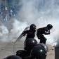 Riot police fire tear gas at Honduran students demanding the resignation of President Juan Orlando Hernandez in Tegucigalpa