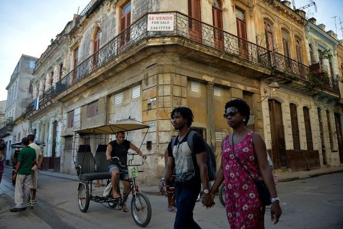 People walk past a building for sale in Havana, Cuba, as US Secretary of State Mike Pompeo warned foreign businesses to steer clear of formerly private properties seized by the island nation