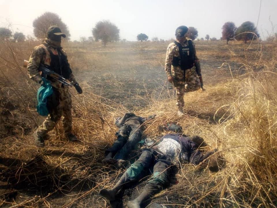 Nigerian soldiers stand over the corpses of neutralised Boko Haram terrorists [Facebook/HQ Nigerian Army]