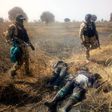 Nigerian soldiers stand over the corpses of neutralised Boko Haram terrorists [Facebook/HQ Nigerian Army]