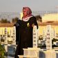 A man in the northern Syrian town of Kobane walks in a graveyard during the funeral of a fighter of the Syrian Democratic Forces killed in an offensive by the Islamic State movement
