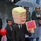 An Iranian man carries an effigy depicting US President Donald Trump carrying a sign reading in Persian "I am not bound by any commitment" during a ceremony celebrating the 40th anniversary of the Islamic Revolution in Tehran on February 11, 2019
