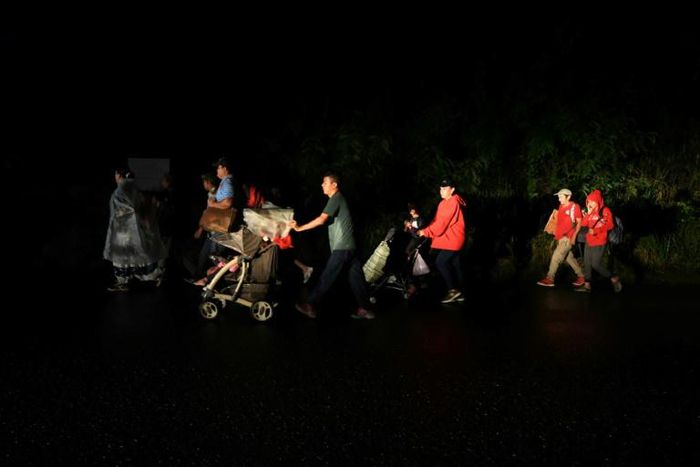 Honduran migrants part of a caravan to the United States leave San Pedro Sula, Honduras on January 14, 2019