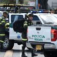 Security forces at the site of a car bombing at a police cadet training school in Bogota