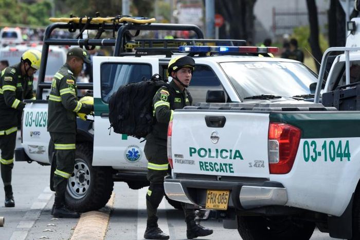 Security forces at the site of a car bombing at a police cadet training school in Bogota