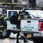 Security forces at the site of a car bombing at a police cadet training school in Bogota