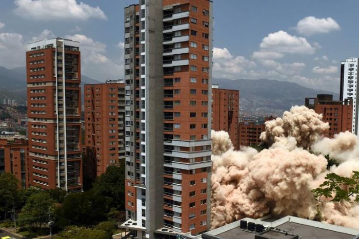 A cloud of smoke rises up from the ground following the demolition of the late drug baron Pablo Escobar's Medellin fortress