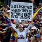 A woman holds a poster demanding free elections during an opposition rally against leader Nicolas Maduro