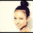 Karrueche Tran styles her hair in a bun