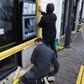 Workers installed wooden planks to protect the windows and ATM of a bank on Friday in Bourges, central France, where many "yellow vest" protesters plan to meet Saturday