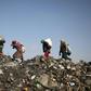 Children scour the dump near Kafr Lusin camp in search of plastic and other things they can sell to buy food