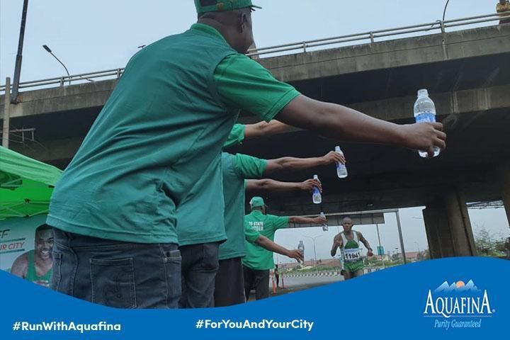 Runners getting refreshed with Aquafina at a Water point