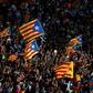 People wave Catalan pro-independence 'Esteladas' flags during a demonstration in Barcelona on October 1, 2018