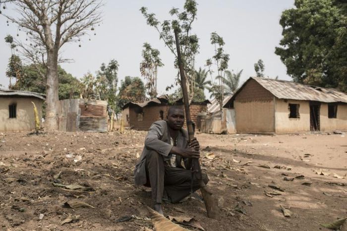 A vigilante clutches his weapon in the village of Bakin Kogi, in Kaduna state, northwest Nigeria -- a region that has long been a centre of unrest fuelled by ethnic and religious tensions