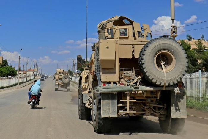Vehicles of the US-led coalition battling the Islamic State group patrol the town of Rmelane in Syria's Hasakeh province on June 5, 2018
