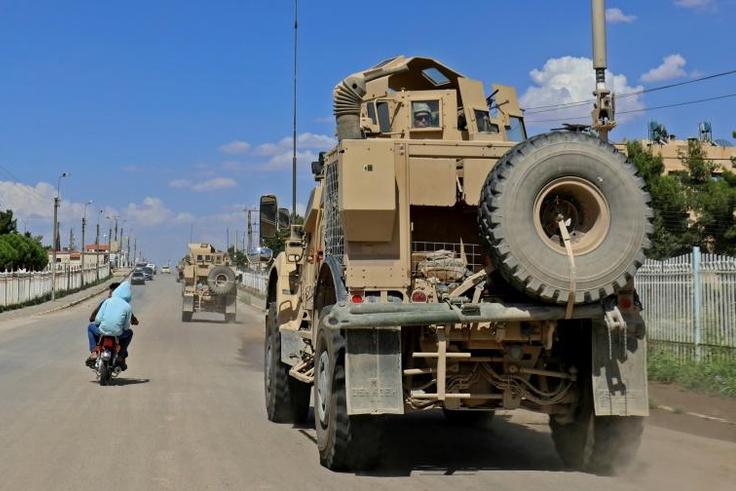 Vehicles of the US-led coalition battling the Islamic State group patrol the town of Rmelane in Syria's Hasakeh province on June 5, 2018