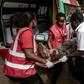 An injured member of the security forces is evacuated from the scene