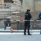 Police officers investigate at the scene where a man set himself on fire in Prague
