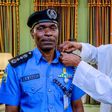 President Muhammadu Buhari decorates Mohammed Adamu as the new Inspector-General of Police [Twitter/@NGRPresident]