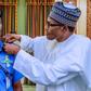 President Muhammadu Buhari decorates Mohammed Adamu as the new Inspector-General of Police [Twitter/@NGRPresident]