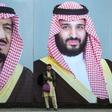 A Pakistani man waits for transport in front of billboards showing portraits of Saudi Arabian Crown Prince Mohammed bin Salman and his father, King Salman bin Abdulaziz, ahead of the Salman's state visit from February 16 - 17