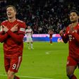 Robert Lewandowski (L) celebrates scoring his 12th Bundesliga goal of the season