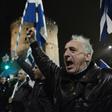 People hold Greek flags and shout slogans in Thessaloniki on December 14, 2018, as they protest Macedonia's name change, which they object to because of the northern Greek province of the same name