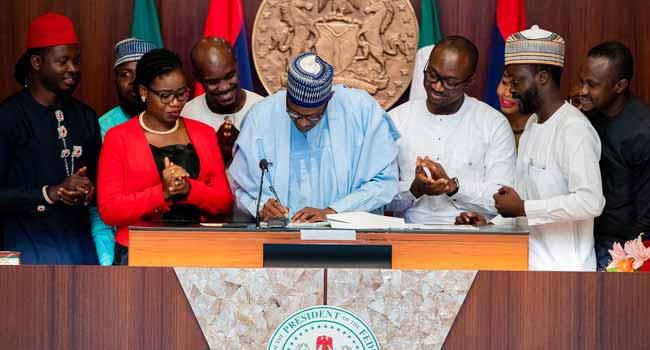 President Buhari signing the Not Too Young To Run Bill (Channels)