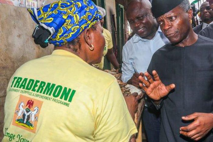 Osinbajo talking with a market woman in Lagos