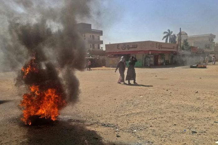 Sudanese protestors burn tyres during an anti-government demonstration on January 18, 2019 in Khartoum