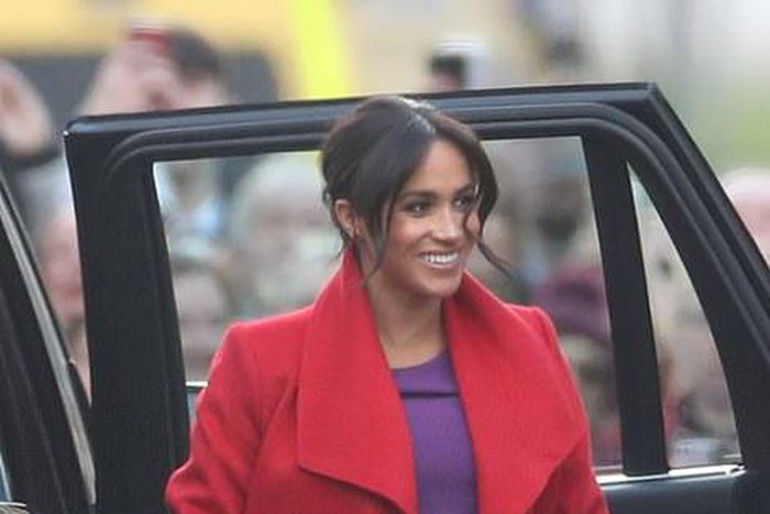 Meghan Markle is a vision in a cromson coat for official royal engagment