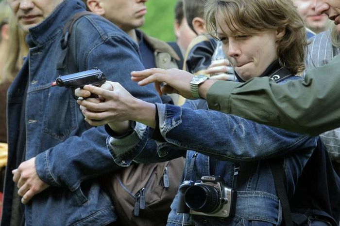 Russia's Soviet-era Makarov pistols, seen here being tried out by journalists at a Moscow weapons shop, has long been used by police and the army