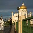 A newlywed couple has their photograph taken at the Sultan Omar Ali Saifuddien mosque in Bandar Seri Begawan, the capital of Brunei, where laws are taking effect that will impose death by stoning for gay sex and adultery