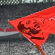 A supporter of incumbent Indonesian president Joko Widodo waves a flag bearing his portrait at an election rally in Jakarta