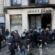 Riot police outside a partially burned Longchamps store on the Champs-Elysees in Paris on Saturday