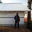 A police officer (pictured March 2019) stands guard inside an Ebola Treatment Centre in Butembo, North Kivu province, where the WHO says there are clear signs the spread of the virus was "contracting"