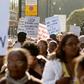 Chagos Islanders leave London's Houses of Parliament with protest signs on October 22, 2008