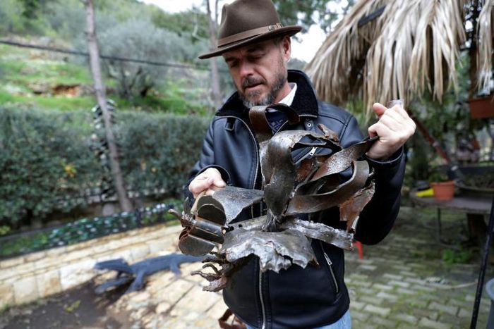 Charles Nassar displays his shrapnel sculptures in a garden south of the Lebanese capital Beirut
