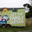 Anger has focussed on Gun City's billboard on a busy highway showing a man teaching two children how to shoot