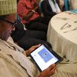 President Muhammadu Buhari checking out his twitter page on a Tablet during a meeting with campaign volunteers in Lagos in 2014. (Sahara Reporters)