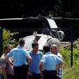 A picture taken on July 1, 2018, north of Paris shows police near a French helicopter Alouette II abandoned by French armed robber Redoine Faid after his escape from prison in Reau.