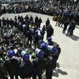Algerian riot police come face to face with anti-government protesters in the capital Algiers
