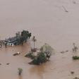 Many people survived the storm and flooding by climbing onto rooftops or up trees where they were waiting to be rescued