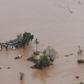 Many people survived the storm and flooding by climbing onto rooftops or up trees where they were waiting to be rescued