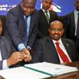 Central African Republic President Faustin-Archange Touadera, left, inks the peace deal next to Sudanese President Omar al-Bashir in Khartoum on February 5