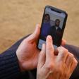 A relative looks at a picture on a mobile phone of Pakistani nationals Naeem Rashid and his son Talha Naeem, who were killed in the attacks to the Christchurch mosques in New Zealand
