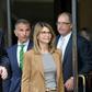 "Full House" star Lori Loughlin (C) and her husband, designer Mossimo Giannulli (L), were among 50 people indicted in the wide-ranging college bribery scandal